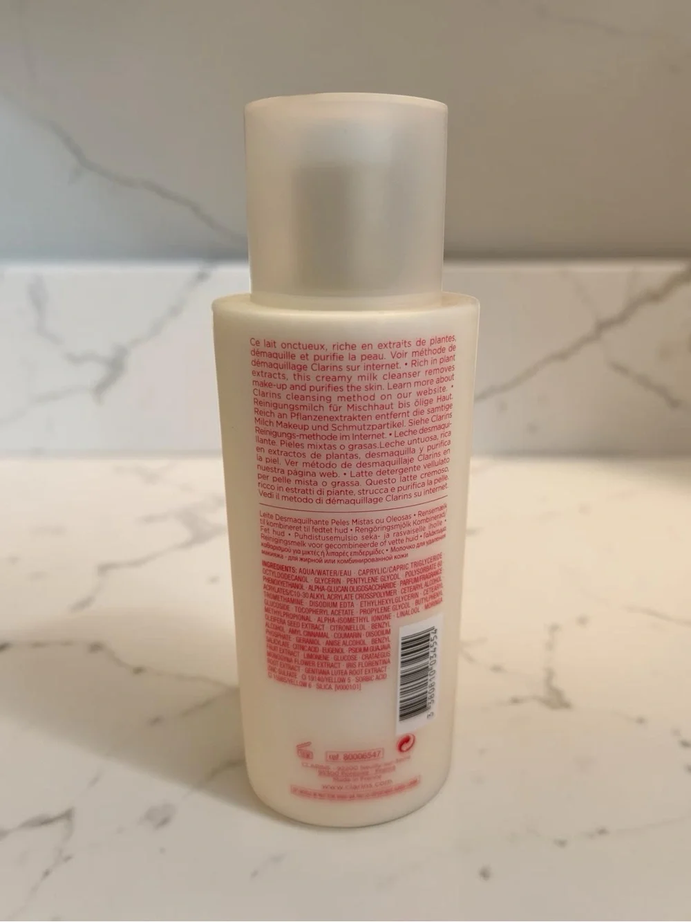 Clarins Cleansing Milk with Red Logo on Cream Bottle